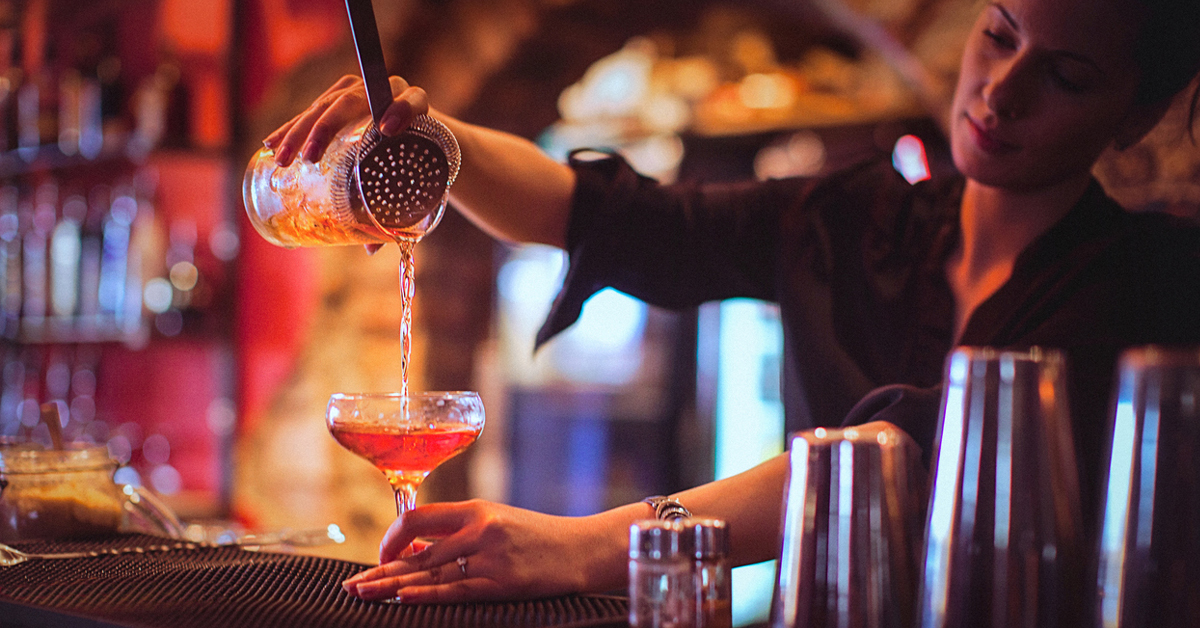 Woman Making Cocktail In Bar