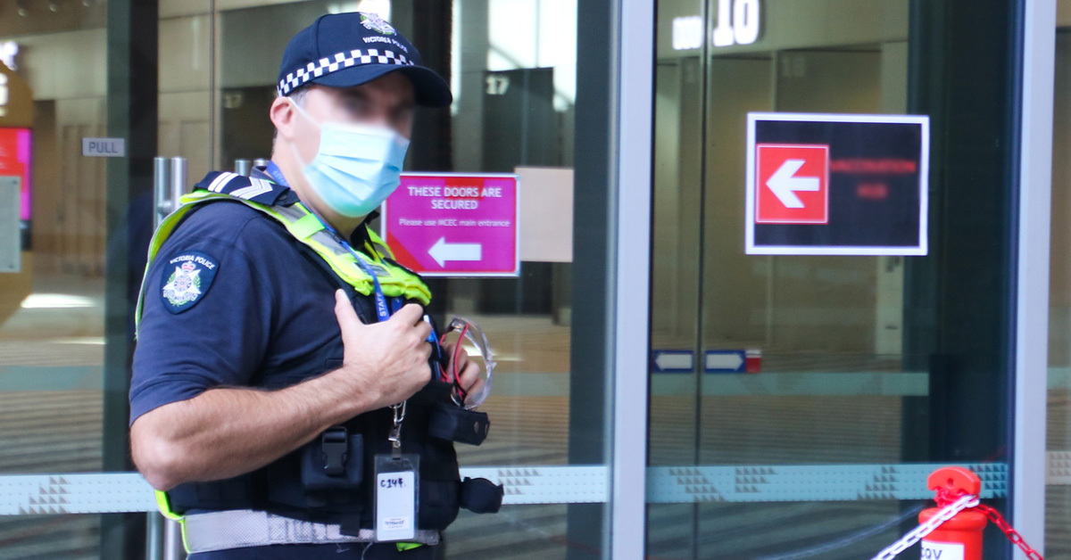Victoria Police Officer Wearing A Mask Outside Building